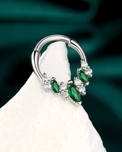 Green gemstone septum ring with clear crystals on white display, silver toned, lightweight stainless steel body