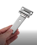 Hand holding stainless steel door hinge for outdoor use and boats beefy heavy duty trailer and barn gate hinge rugged weather resistant