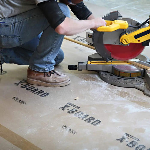 Contractor using X Board Seam Tape Tan 1.89 Inch By 164 Foot Contractor Grade Adhesive for surface protection with saw