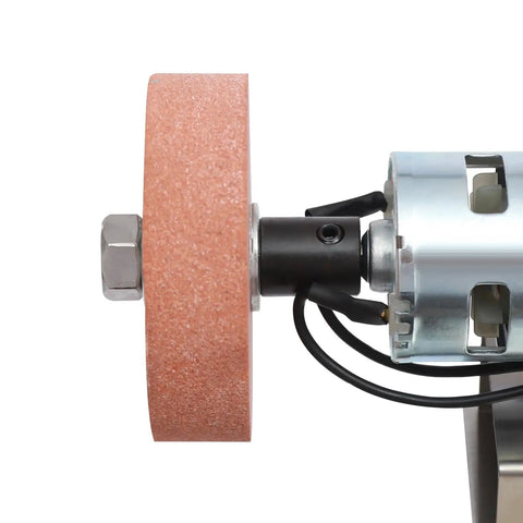 Close-up of No Hassle Workhorse Mini Belt Sander and Knife Sharpener's grinding wheel and motor for precise hobby buffing.