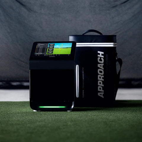 Approach R50 Golf Launch Monitor And Simulator Bundle with Case, featuring 10-inch color display, on green surface