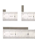 Front view of stainless steel shaft adapters; two small blocks and a long sleeve bar with ruler for scale.