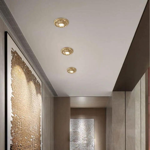 UWYTGF 6 Pack Led Can Lights Retrofit Recessed Lighting installed in a ceiling, featuring brass material and decorative trim.