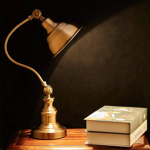 Brass Adjustable Desk Lamp With Rotary Shade Vintage Task Light on table beside books, highlighting dark room corner