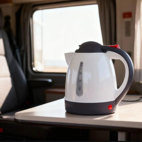 Game Changer Dual Voltage Car Kettle Works With 12V And 24V Systems Portable Water Heater 1 Liter size on a table in a vehicle.