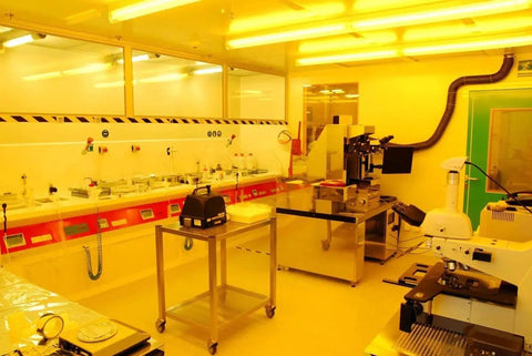 Lab with equipment for anti static wrist straps set woven fabric grounding work, showing yellow-lit electronics workstation.