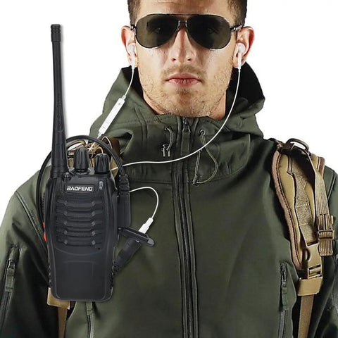 Man wearing army green jacket with sunglasses, using Two Pin To Three Point Five Millimeter Earpiece Adapter for Walkie Talkie Gear