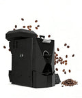 Electric Coffee Roaster 500 Gram Capacity With Three Smart Roast Settings Smokeless Filter Chaff Collector Direct Fire Heating Stainless Steel Build, black machine with coffee beans.