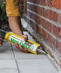 Applying Mor-Flexx Gray Acrylic Latex Caulk For Mortar, Stucco, And Grout Repair on outdoor brick seam with caulking gun