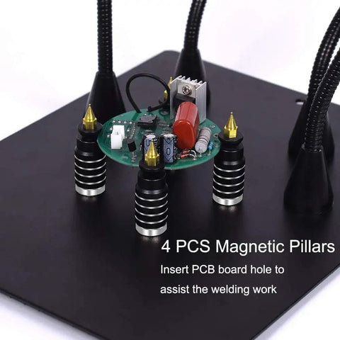 Adjustable Soldering Helping Hands with four magnetized pillars and flexible arms holding a PCB on steel base for precise assembly.