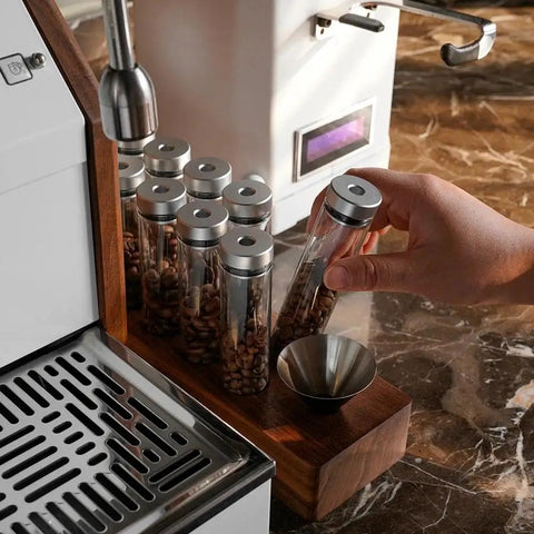 12 Piece Single Dose Coffee Bean Storage Tubes With One Way Exhaust Valve Glass Vials On Sturdy Walnut Wood Base for easy coffee dosing