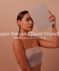 Woman holding Your Go To LED Travel Vanity Mirror With 3 Color Ring Light For Consistent Lighting Dimmable Brightness Handheld Portable Design Built In Touch Sensor Rechargeable Micro USB White Finish On The Go Grooming