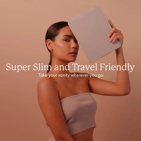 Woman holding Your Go To LED Travel Vanity Mirror With 3 Color Ring Light For Consistent Lighting Dimmable Brightness Handheld Portable Design Built In Touch Sensor Rechargeable Micro USB White Finish On The Go Grooming