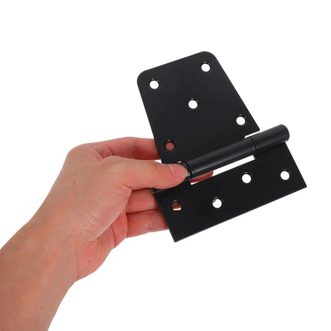 Hand holding black Heavy Duty Three Point Five Inch Gate Strap Hinges Weld On For Shed Doors And Wood Fences Two Piece Set Tough As Nails