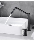 Faucet, Desk Mounted 360 Rotate Foldable Basin Faucet Mixer Hot and Cold Sink Tap Rotate Folding Spout Kitchen Matter Black in use over white basin.
