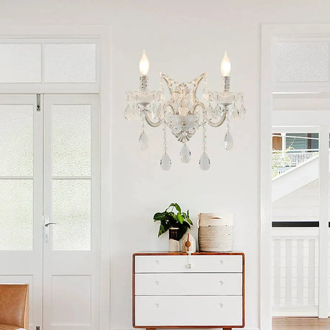 White Crystal Wall Sconce Lighting With Modern K9 Glass Crystal Drops Shade above a white dresser in living room