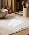 Pro Grade Protective Corner Guards for Picture Frames and Glass Tables shown on a desk with bowls and stationery items.