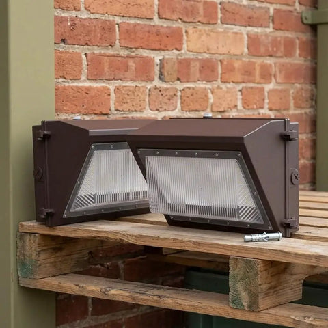 LIFKOME Outdoor Security Flood Light 2 Pack Aluminum Dusk to IP66 on wooden pallet against brick wall, showing two rectangular lights.