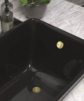 Top Shelf Brushed Gold Bathtub Drain Kit And Overflow Faceplate in black tub, showcasing rust resistant metal fittings.