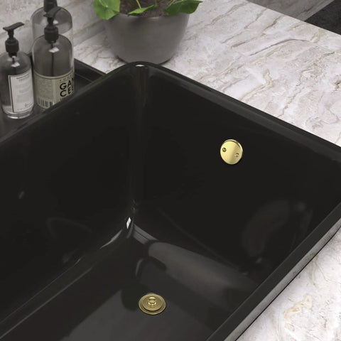 Top Shelf Brushed Gold Bathtub Drain Kit And Overflow Faceplate in black tub, showcasing rust resistant metal fittings.
