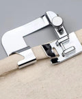 Universal Sewing Machine Presser Feet Set For Home Electric Models With Zipper Foot Binder Attachment And Overlock Presser, close-up of binder foot on fabric.