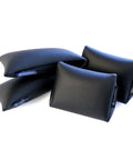 Spine Alignment Cushions Four Pack for Posture Fix and Back Pain Relief, black rectangular pads and wedges for body support.