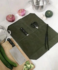 Durable Waxed Canvas Knife Storage Bag For Chefs And Outdoor Lovers with open compartments holding utensils on kitchen counter