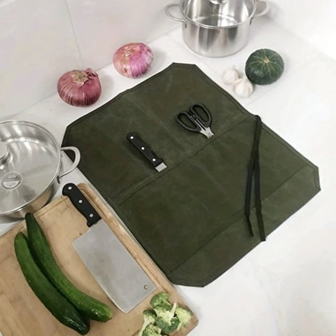 Durable Waxed Canvas Knife Storage Bag For Chefs And Outdoor Lovers with open compartments holding utensils on kitchen counter
