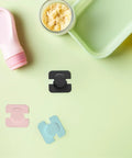 Four Pack Easy Install Refrigerator Door Locks for Childproofing Your Fridge and Freezer Cabinets, colorful ABS plastic locks on green surface