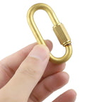 Hand holding Brass Quick Links D Shape Screw Locking M4 5/32 Inch, showing corrosion-resistant connector for outdoor use.