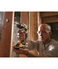 Person using Compact 20V Max XR Li Ion Brushless Drill And Driver With Dual Speed Settings for wood drilling in tight space