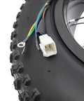 Close-up of Beefed Up 1500W 48V Ebike Conversion Kit with 20 inch rear hub motor wiring connectors and tire tread detail.