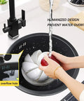 Stainless Steel Kitchen Sink With Black Faucet For Small Kitchens, hands washing a red apple, overflow prevention feature.
