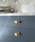 Oval Fluted Zinc Alloy Cabinet Knobs In Champagne Bronze on blue dresser drawers in a retro kitchen setting