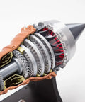 Close-up of TR900 Aero Aircraft Engine Model Kit That Actually Runs with visible turbine and gears in transparent housing.