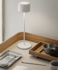 Super Sleek Portable LED Lamp In Warm Gray on desk, battery powered, minimalist design, perfect for home or desk, timeless modern vibe