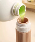 Pouring liquid into TSA Approved Travel Bottles Set Three Ounce Silicone Squeeze Containers Leak Proof BPA Free