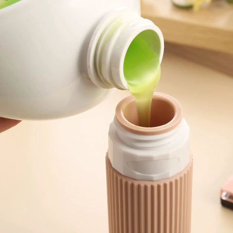 Pouring liquid into TSA Approved Travel Bottles Set Three Ounce Silicone Squeeze Containers Leak Proof BPA Free