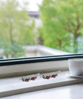 Top Tier Heavy Duty 4 Piece Stainless Steel Sliding Window Rollers With Double Wheel Bearing for smooth sleek motion near a window.