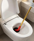 Heavy Duty Manual Toilet Auger Six Foot Steel Drain Snake With Long Handle To Burst Through Stubborn Clogs In Residential Drains And House Sewer Lines Without Any Hassle in action, clearing a toilet clog.