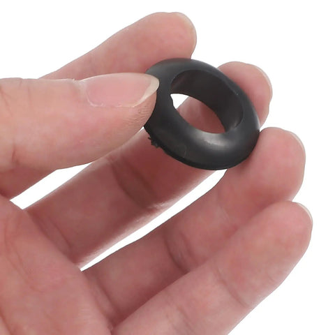 Heavy Duty Black Rubber Grommet Kit 4 Pack For Distribution Boxes Protect Cables With Flexible Heat Resistant Grommets For Wiring And Quick No Fuss Sealing Weatherproof Protection, black rubber grommet held in hand