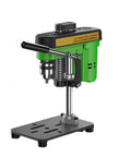 XVIIUIFOI Mini Drill Press With Dual Power Modes Adjustable Depth Control For Wood Metal Steel PVC Projects Ideal Benchtop Drilling Machine For Hobbyists And DIY Enthusiasts Compact Versatile Design on a workbench.