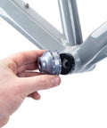 Hand using 16 Notch Bottom Bracket Tool For Quick Removal And Installation Fits Shimano Ultegra BBR60 And Deore XT MT 800 on bike frame