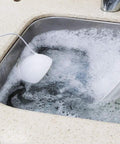 Slick Portable Usb Dishwasher With Ultrasonic Deep Clean And High Pressure Water Spray That Tackles Greasy Pots And Pans Hassle Free For Small Kitchens Apartments Or Rv Outings In Matte Blue in soapy water.