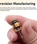 Close-up of a hand holding a brass valve core, part of the 17 Piece Car AC Valve Core Kit Pro Grade With R12 To R134a Conversion.