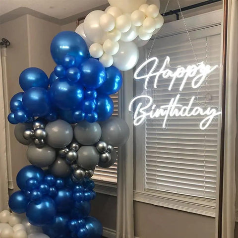 Large Happy Birthday LED Neon Sign 28 Inch Dope Neon Light glowing beside blue and gray balloon arrangement indoors.