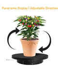 Must Have Remote Controlled 360 Rotating Turntable For Jewelry Photography And Live Streaming With Adjustable Speed Silent Motor Operation, showcasing a potted plant on a black rotating display stand.
