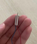Hand holding Hollow Cup Drone Propellers And Micro Motors Kit For Quadcopters Including 716 Propellers And 614 Motors RC