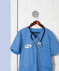 No Drill Needed Heavy Duty Stainless Steel Wall Hooks 6 Pack Adhesive Coat Hanger Set For Bathroom And Hallway holds a blue scrub top.