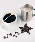 Stainless Steel Milk Frothing Pitcher 12oz 350ml With Dual Inside Measurement Scales For Precise Pouring And Latte Art next to coffee cup